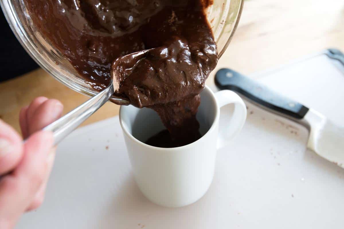 How to Make a Brownie in a Mug: Pouring brownie batter into a mug
