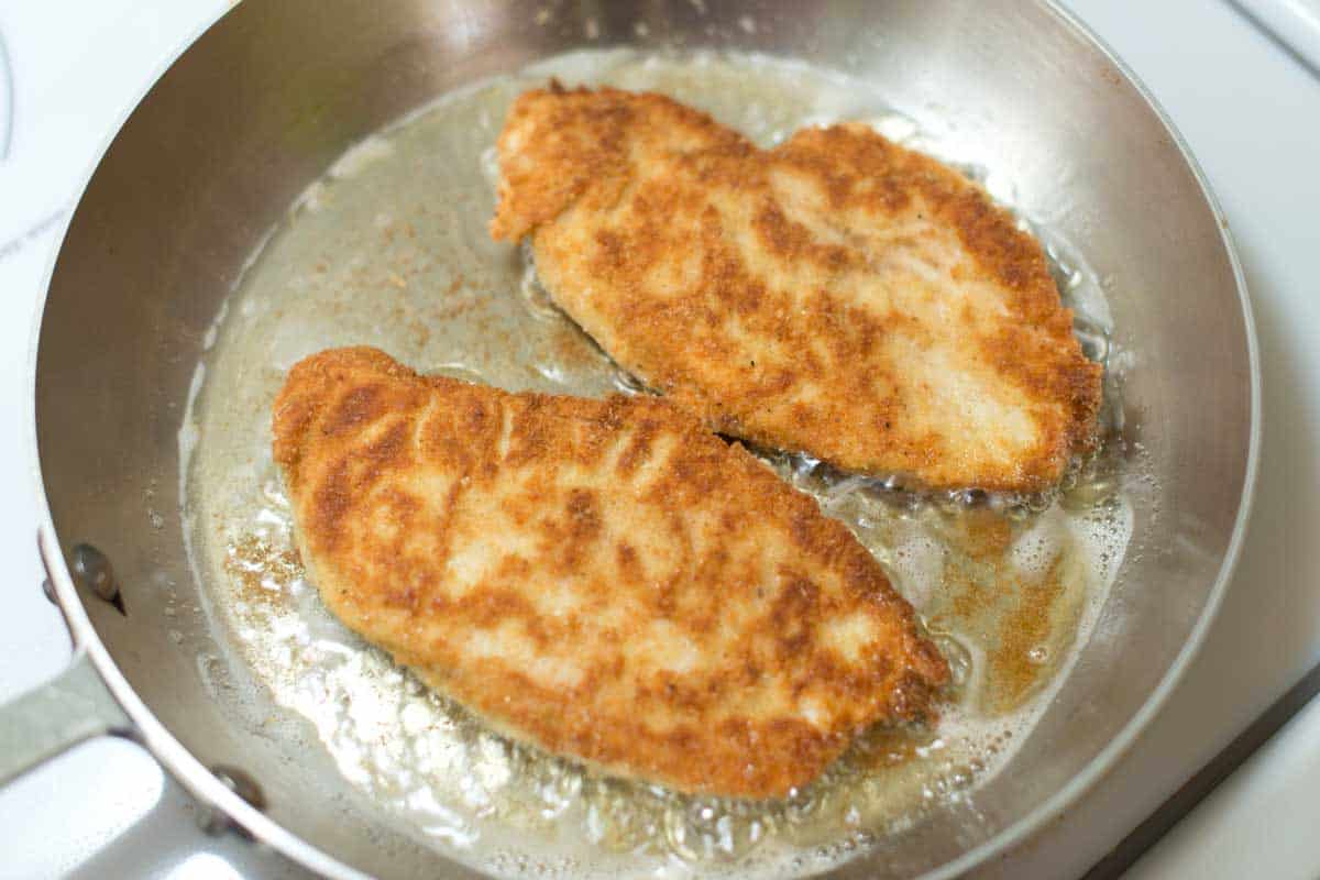 Pan frying chicken for the Best Chicken Parmesan