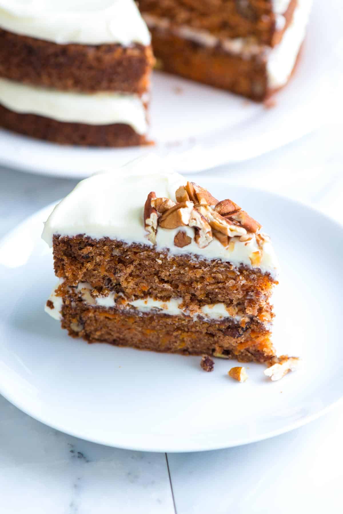 Slice of homemade carrot cake with cream cheese frosting.