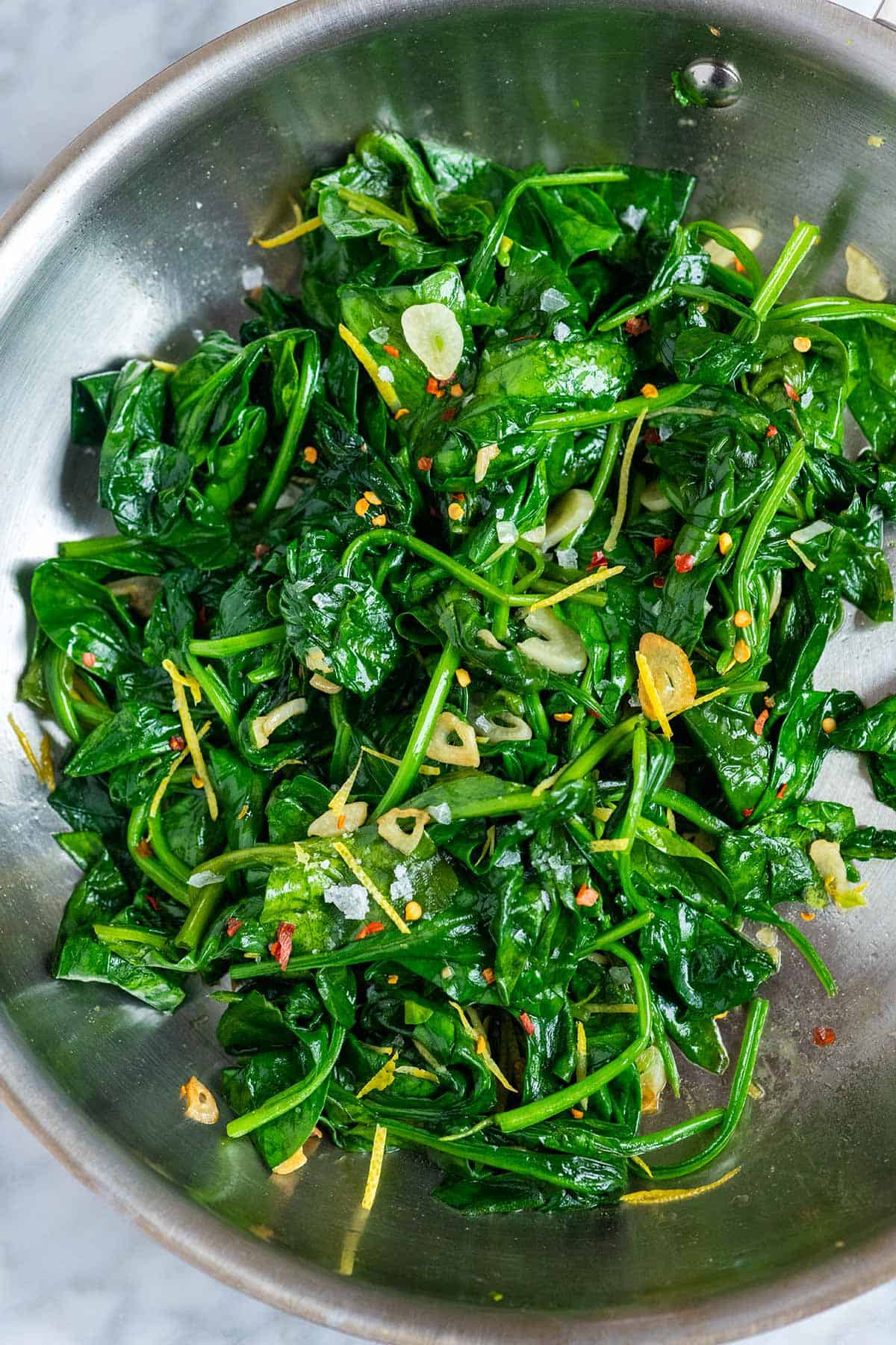 A skillet of sautéed spinach with garlic.