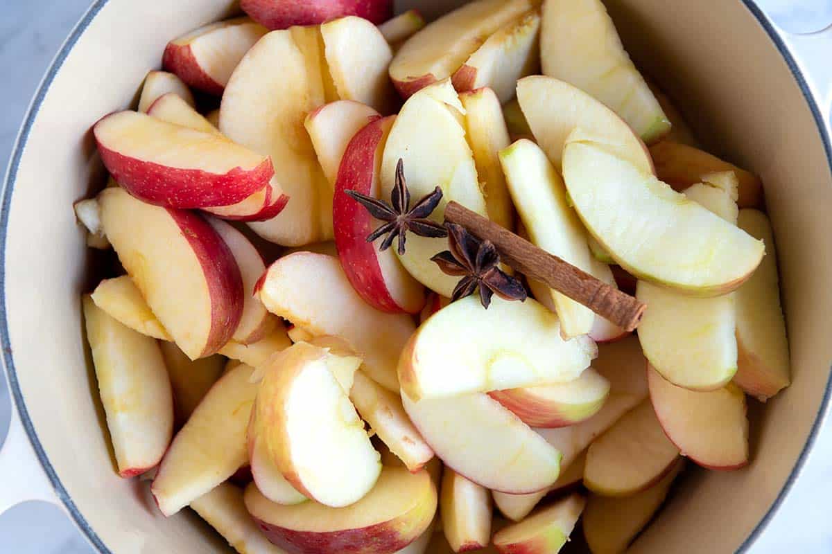 How to Make Applesauce: Apples in a pot with cinnamon ready to cook for homemade applesauce.