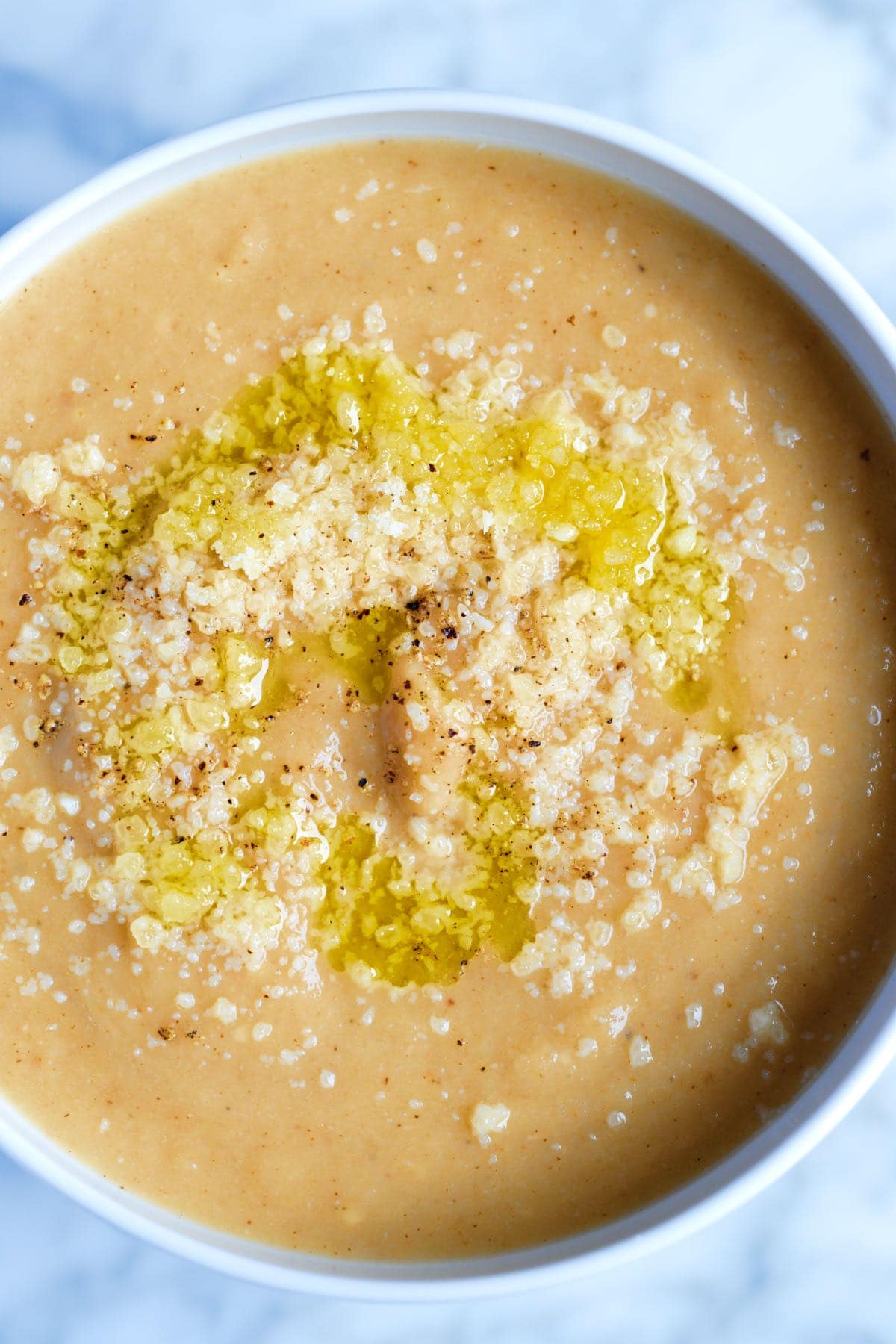A bowl of roasted cauliflower soup with parmesan on top