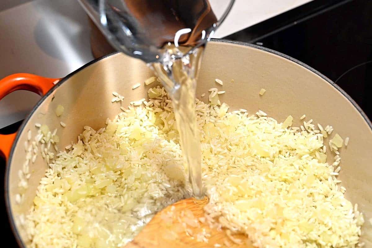 How to Make Cilantro Lime Rice - Toasting the rice with oil and onion before adding water.