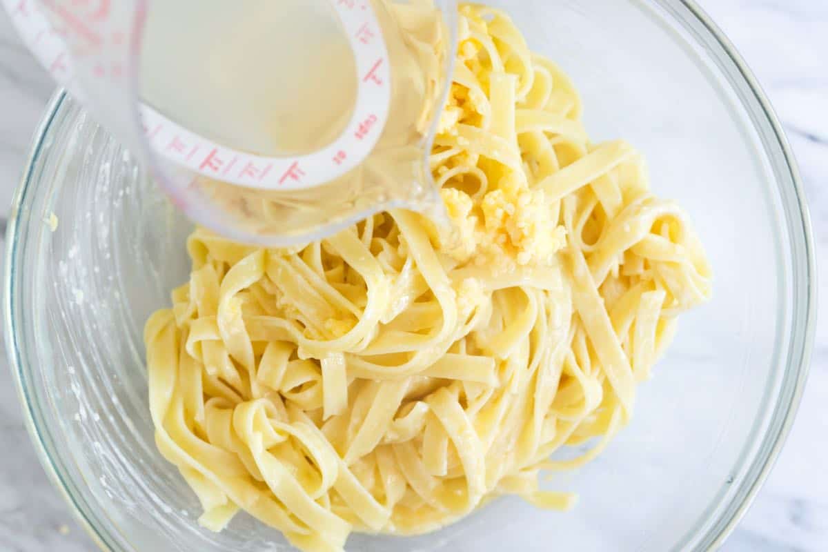 How to make fettuccine Alfredo - adding the pasta cooking water to make the Alfredo sauce