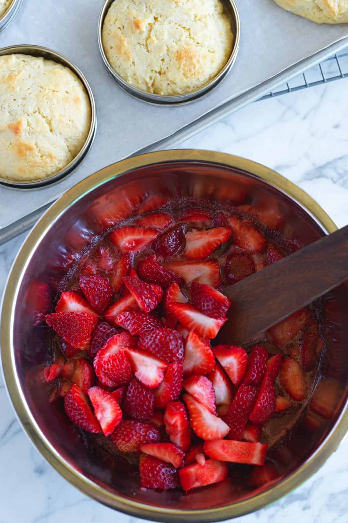 Strawberries in syrup and baked shortcake ready to assemble