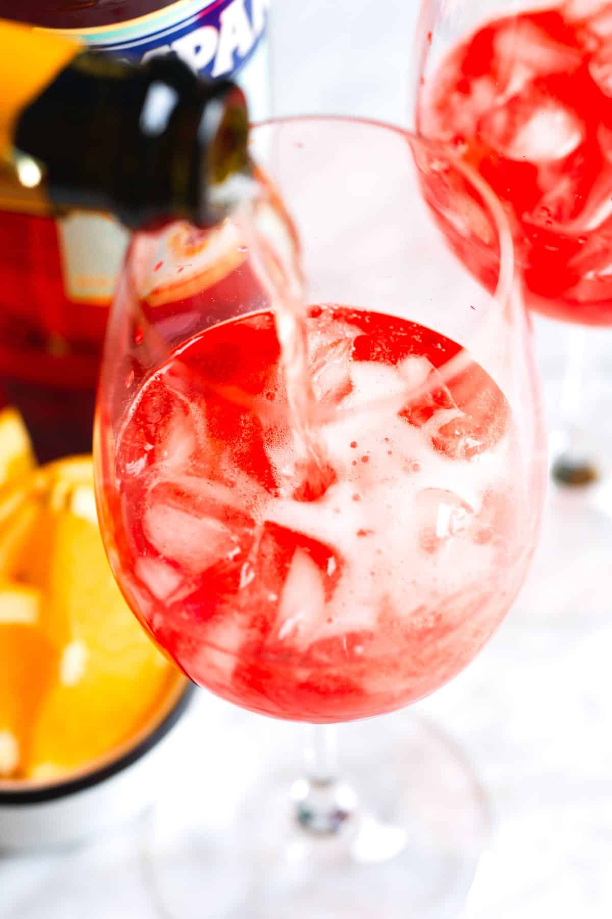 How to Make a Campari Spritz: Pouring in the Prosecco